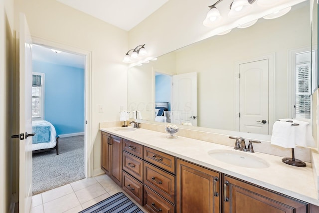 ensuite bathroom featuring double vanity, a sink, and ensuite bathroom