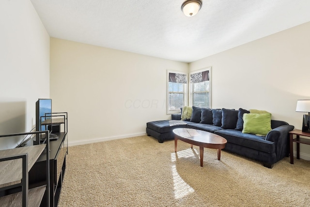 carpeted living area with baseboards