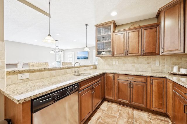 kitchen featuring a sink, brown cabinets, dishwasher, glass insert cabinets, and pendant lighting