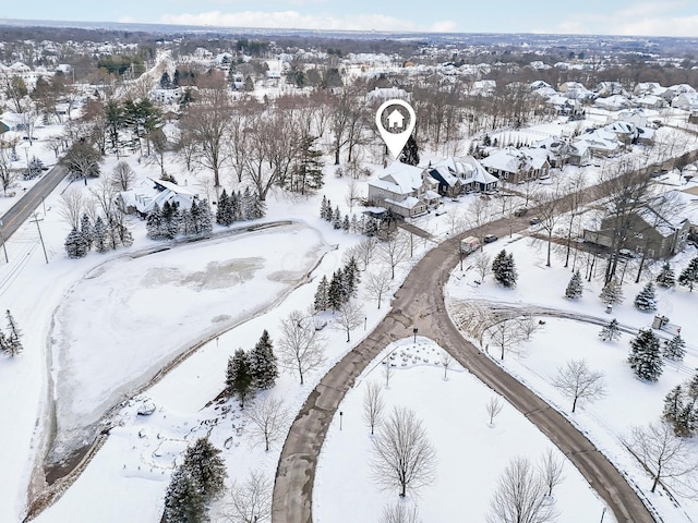 snowy aerial view with a residential view