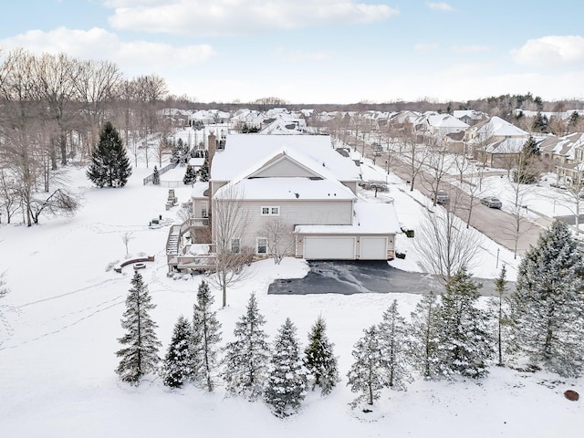 snowy aerial view with a residential view