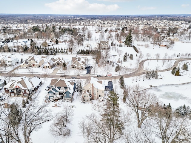 snowy aerial view with a residential view