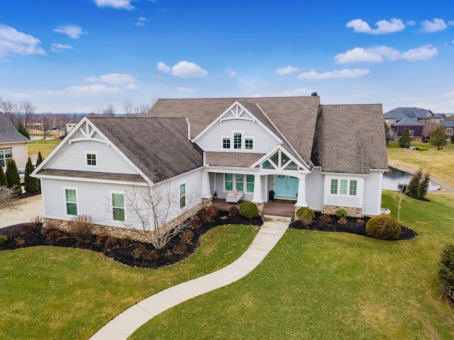 view of front of house featuring roof with shingles, a chimney, and a front yard