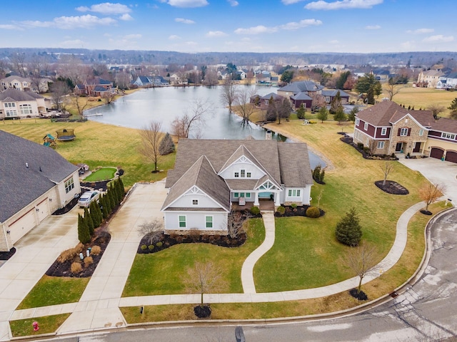 birds eye view of property with a water view and a residential view