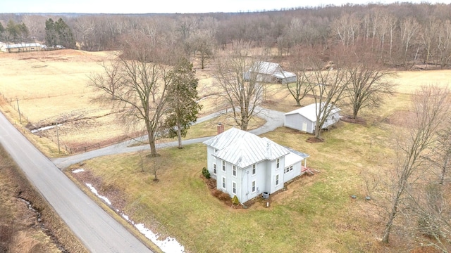 birds eye view of property featuring a view of trees