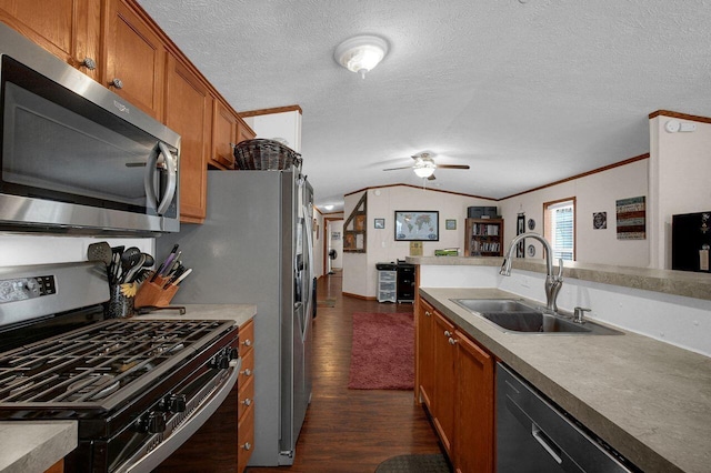 kitchen featuring lofted ceiling, stainless steel appliances, dark wood-style flooring, a sink, and brown cabinets