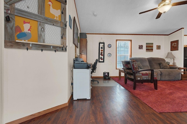 living room featuring a ceiling fan, crown molding, baseboards, and wood finished floors