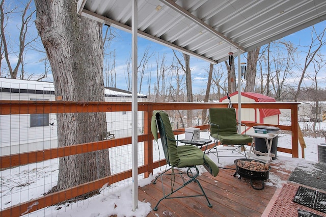 snow covered deck with a fire pit