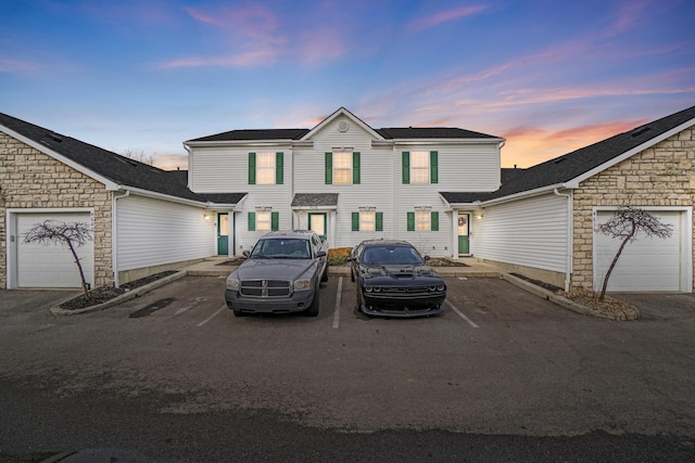 view of front of property with a garage and stone siding