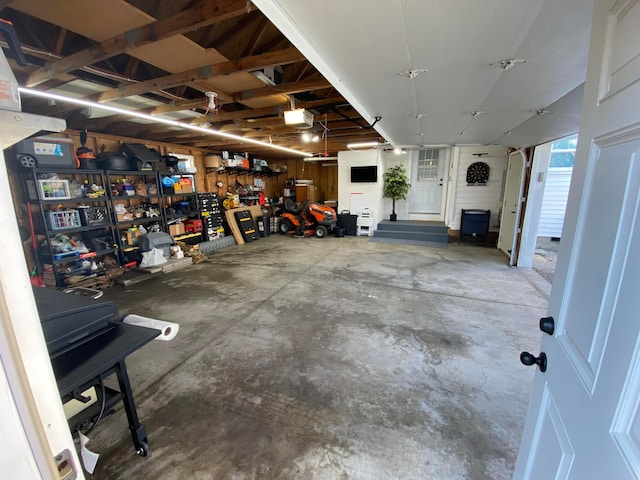 garage featuring a garage door opener and a workshop area