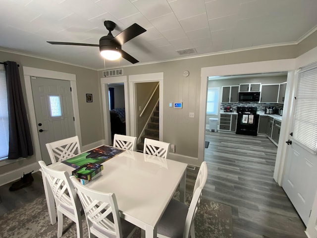 dining space with stairs, visible vents, dark wood finished floors, and ornamental molding