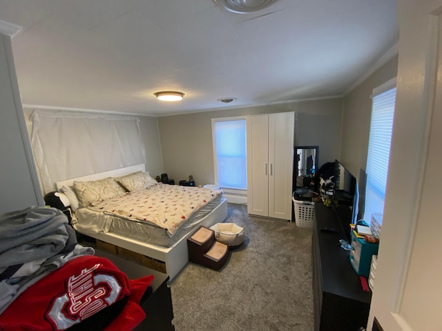 bedroom with visible vents, dark carpet, and ornamental molding