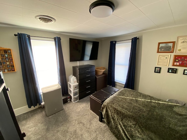 bedroom featuring carpet floors, visible vents, and baseboards