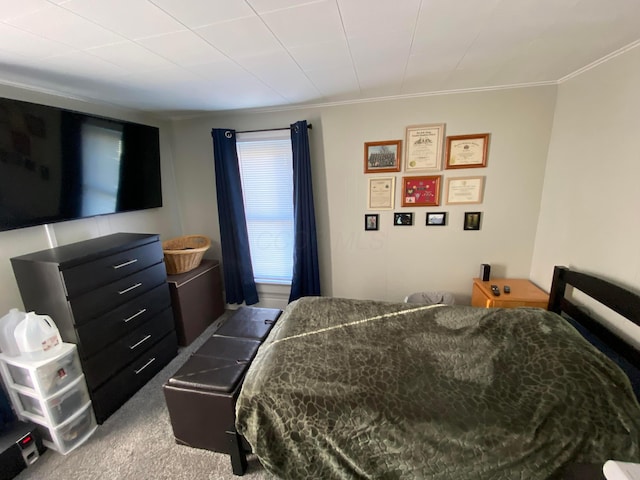 bedroom with carpet floors and ornamental molding