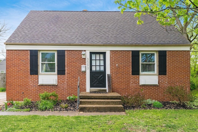 3093 Hamilton Ave, Columbus, OH 43224 - view of front of house featuring brick siding, roof with shingles, and a front lawn