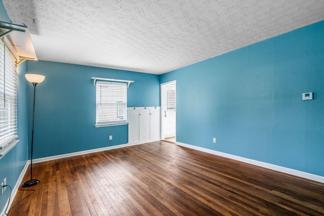 3093 Hamilton Ave, Columbus, OH 43224 - spare room featuring wood-type flooring, a textured ceiling, and baseboards