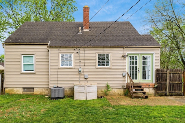 3093 Hamilton Ave, Columbus, OH 43224 - back of property with fence, central AC, french doors, a chimney, and entry steps
