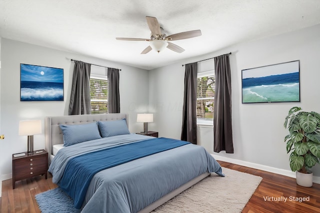 3093 Hamilton Ave, Columbus, OH 43224 - bedroom with baseboards, ceiling fan, multiple windows, and wood finished floors