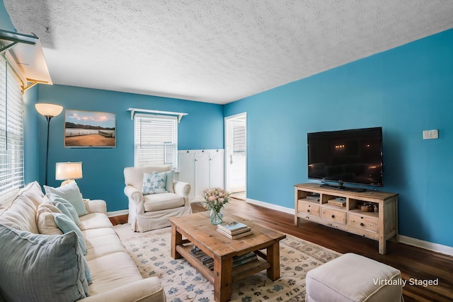 3093 Hamilton Ave, Columbus, OH 43224 - living area with a textured ceiling, baseboards, and wood finished floors