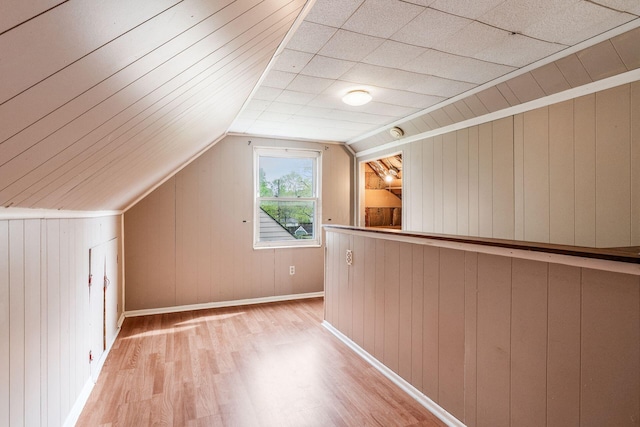 3093 Hamilton Ave, Columbus, OH 43224 - bonus room featuring wooden walls, baseboards, lofted ceiling, and light wood finished floors