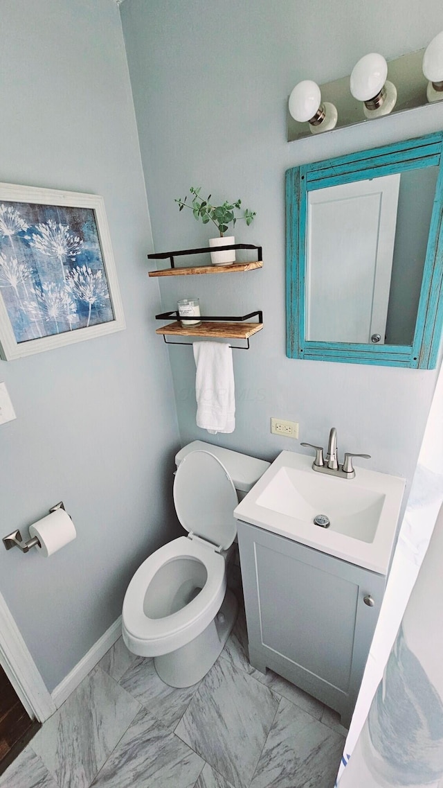 3093 Hamilton Ave, Columbus, OH 43224 - bathroom with vanity, marble finish floor, baseboards, and toilet