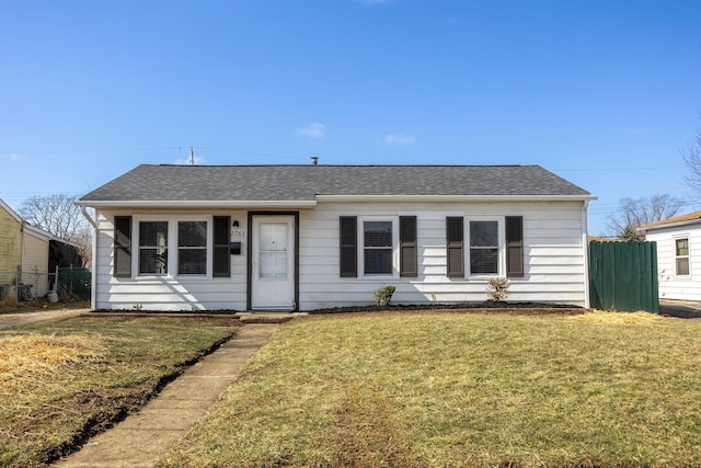 view of front of house with a front yard and fence