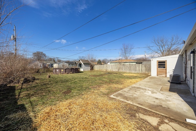 view of yard featuring a patio, a storage shed, central AC, fence, and an outdoor structure