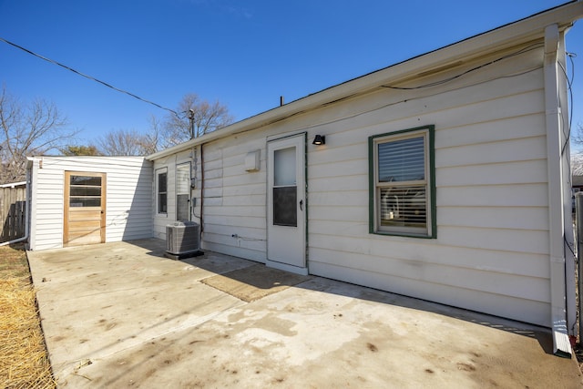 back of house with central AC unit and a patio