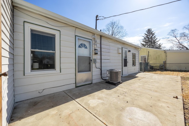 rear view of house featuring central AC, a patio area, and fence