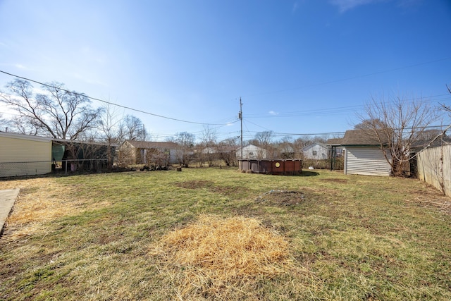 view of yard featuring an outdoor pool and fence