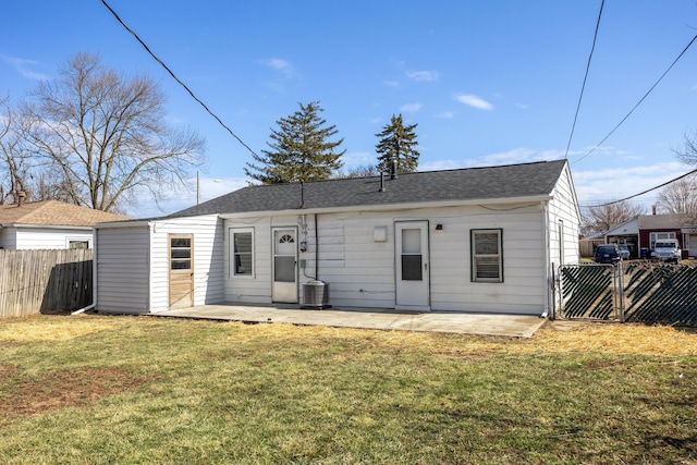 rear view of house with a yard, fence, and a patio