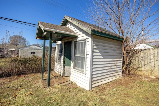 view of shed featuring fence