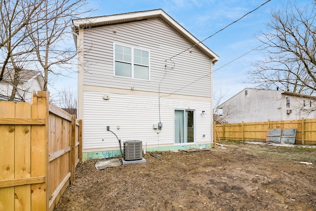 back of house featuring cooling unit and fence