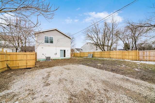 back of property featuring central AC unit and fence private yard