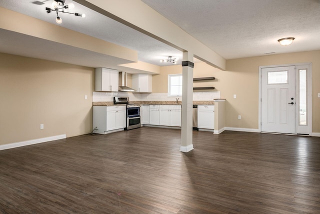 kitchen with open shelves, stainless steel appliances, open floor plan, white cabinetry, and wall chimney range hood