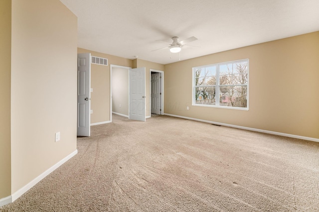 unfurnished bedroom featuring light carpet, visible vents, and baseboards