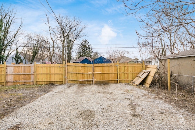 view of yard with fence and a gate