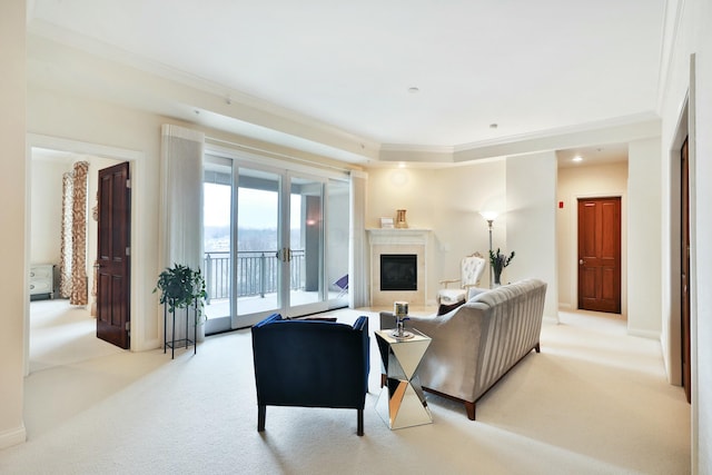 carpeted living area featuring a glass covered fireplace, crown molding, and baseboards