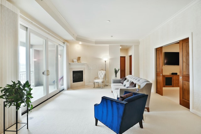 carpeted living area with baseboards, crown molding, and a glass covered fireplace