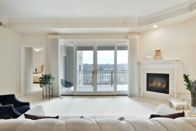 living room with visible vents, a high end fireplace, crown molding, carpet flooring, and recessed lighting