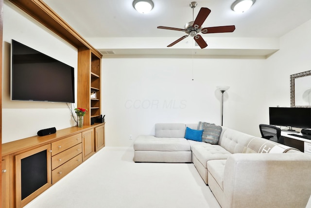 living room with carpet floors, ceiling fan, and visible vents