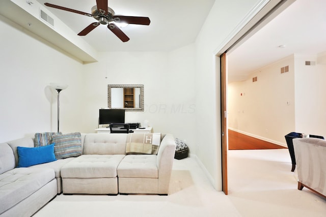 living room featuring a ceiling fan, visible vents, and baseboards