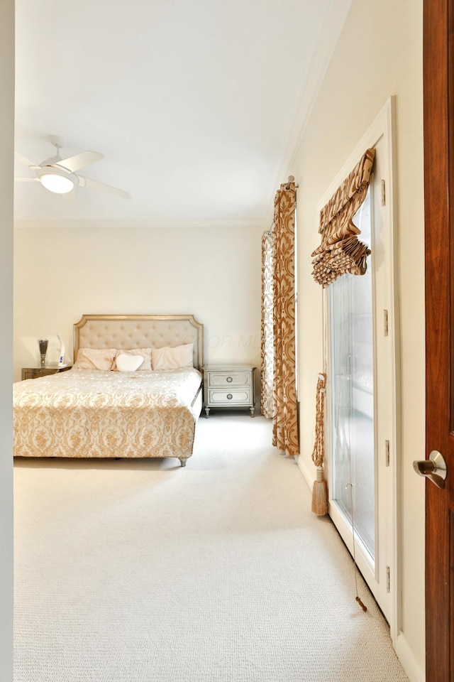 bedroom with carpet floors, crown molding, and ceiling fan