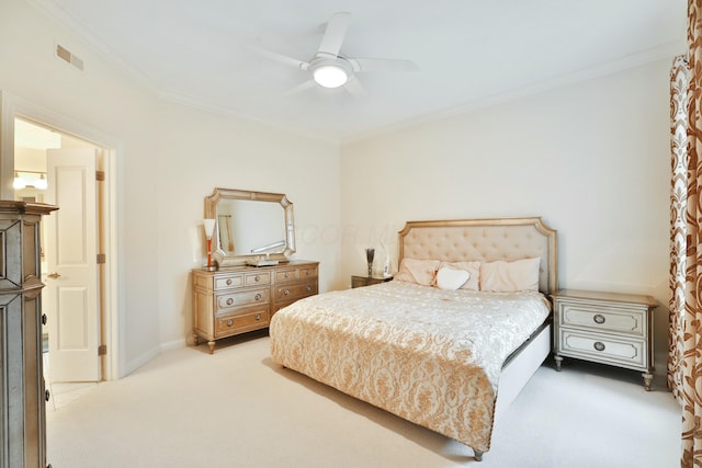 bedroom featuring carpet flooring, a ceiling fan, baseboards, visible vents, and crown molding