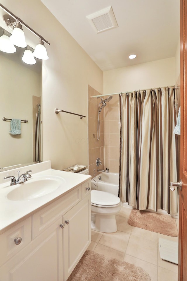 bathroom featuring tile patterned flooring, toilet, vanity, visible vents, and shower / tub combo with curtain