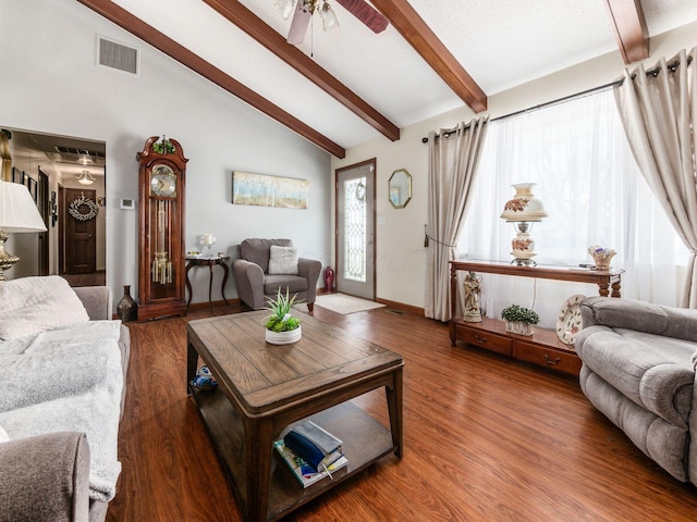 living room with visible vents, lofted ceiling with beams, ceiling fan, wood finished floors, and baseboards