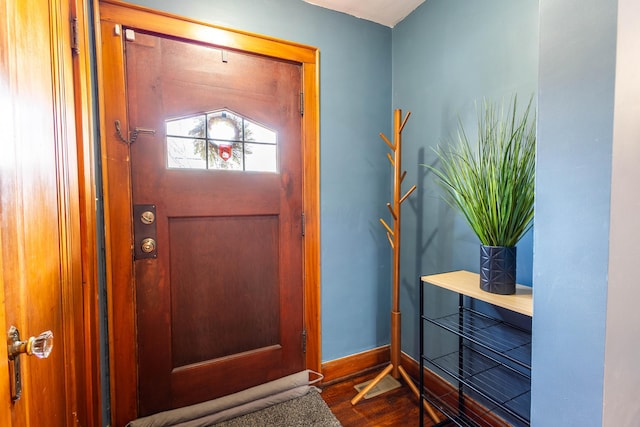 foyer entrance featuring dark wood-style floors and baseboards