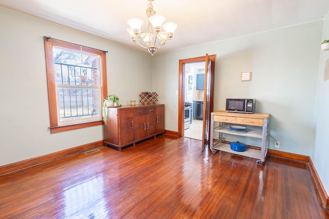 interior space with visible vents, baseboards, and wood finished floors