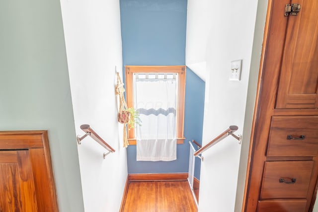 stairs featuring baseboards and wood finished floors