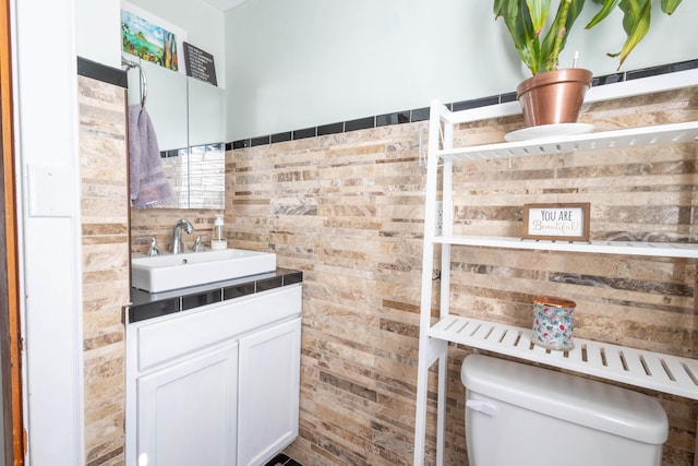 half bathroom with toilet and vanity